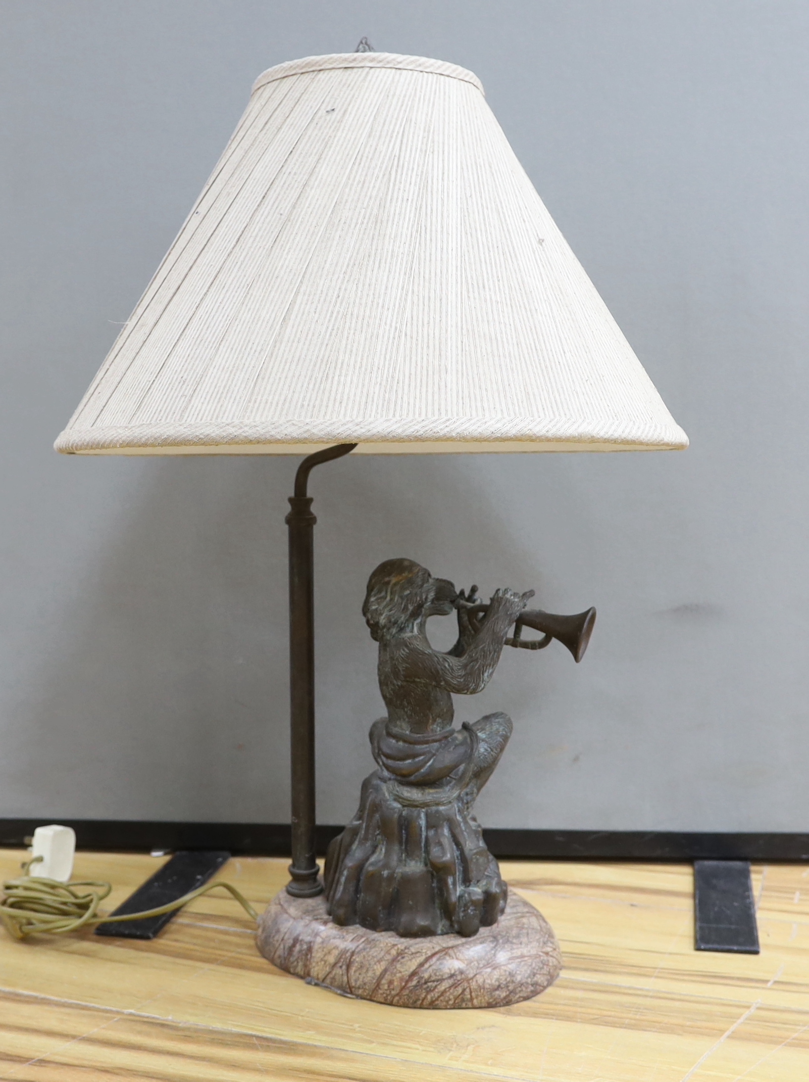 A bronzed metal monkey trumpet playing table lamp, approx. 70cm high including shade